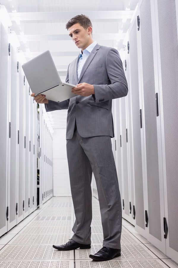 Businessman Standing with Laptop